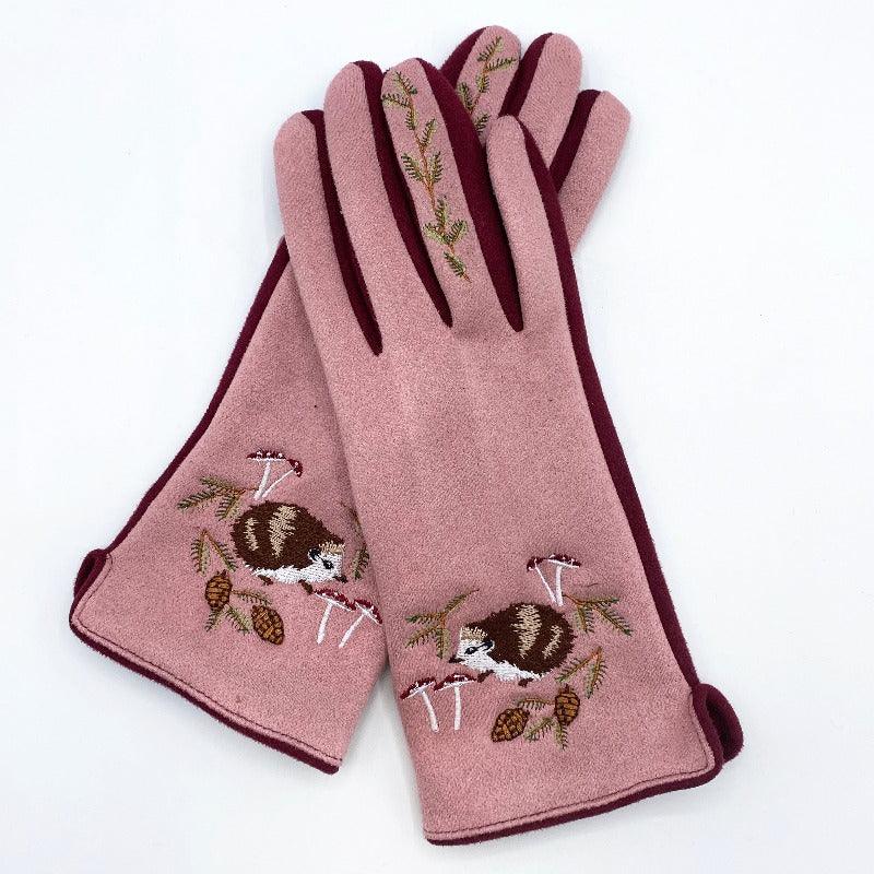 Pink-coloured gloves with an embroidered hedgehog and foliage details.