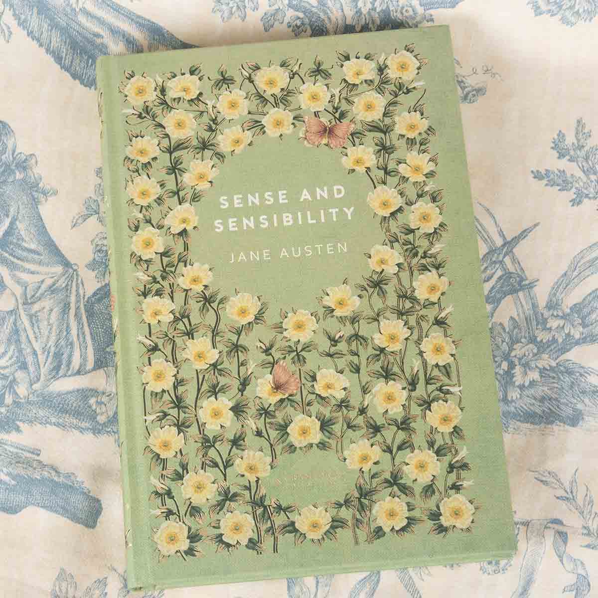 Front cover is washed green with cream flowers and red butterflies decorating the cover