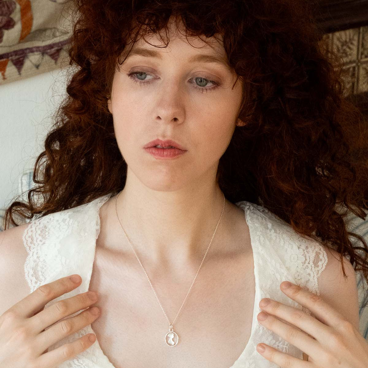 Silver Spinner Necklace showing Jane Austen's Silhouette on a womans neck