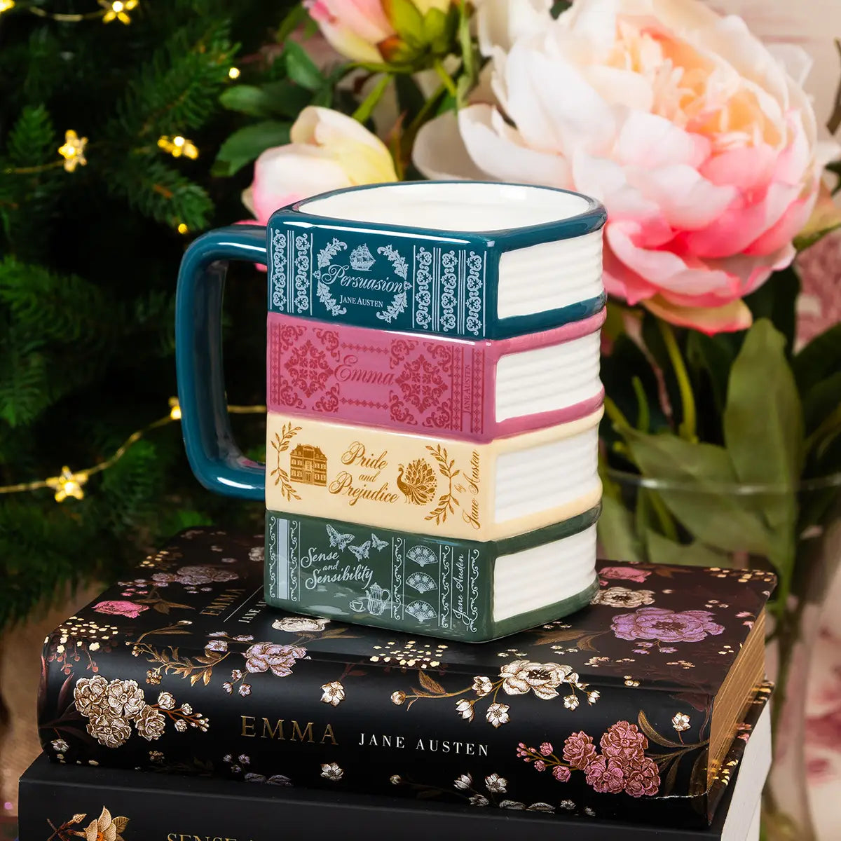 Lifestyle shot of stacked books jane austen mug on some stacked mugs and against a floral background