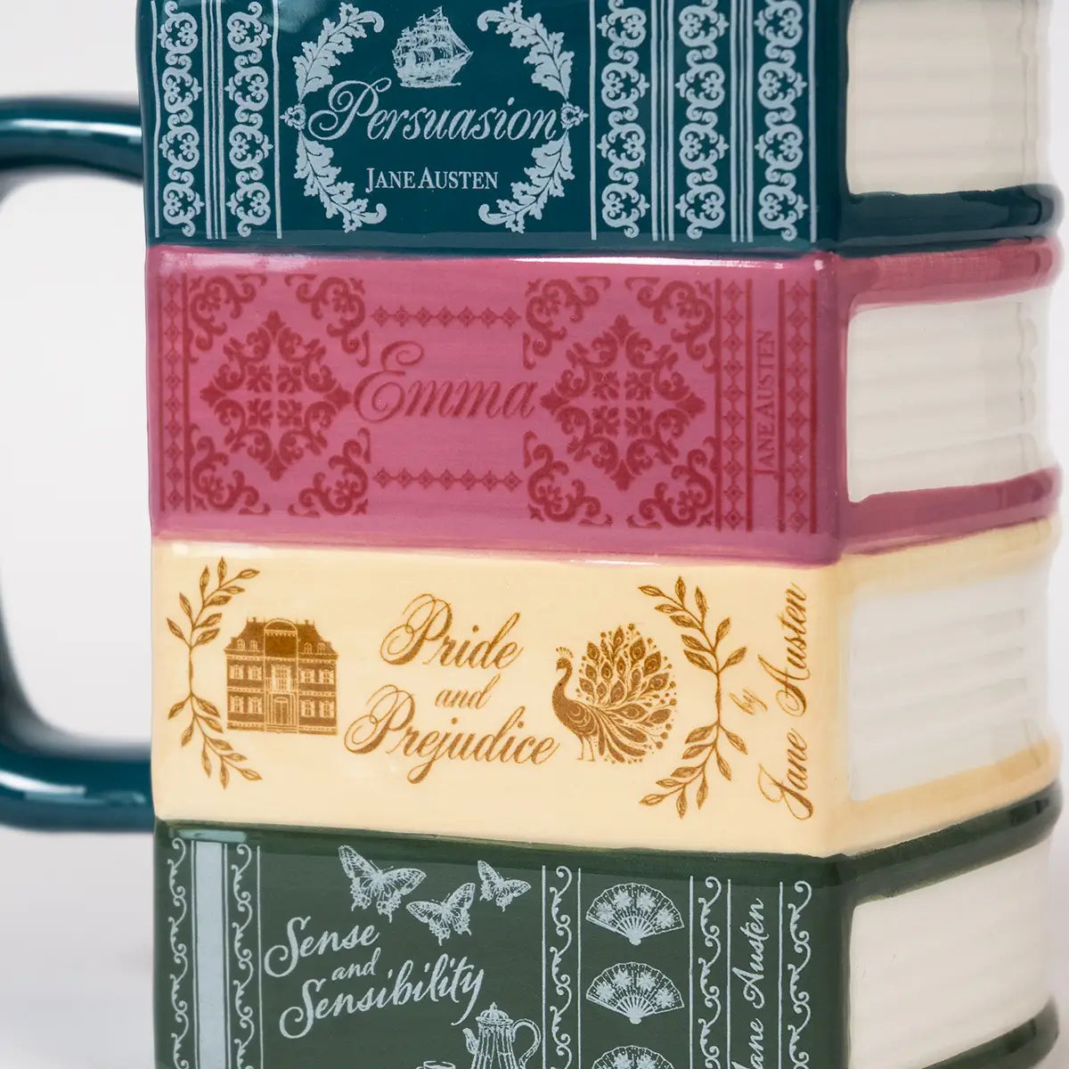 Close-up of 'spine' details on Jane Austen themed stacked books mugs, featuring the titles of Persuasion, Emma, Pride and Prejudice, and Sense and Sensibility