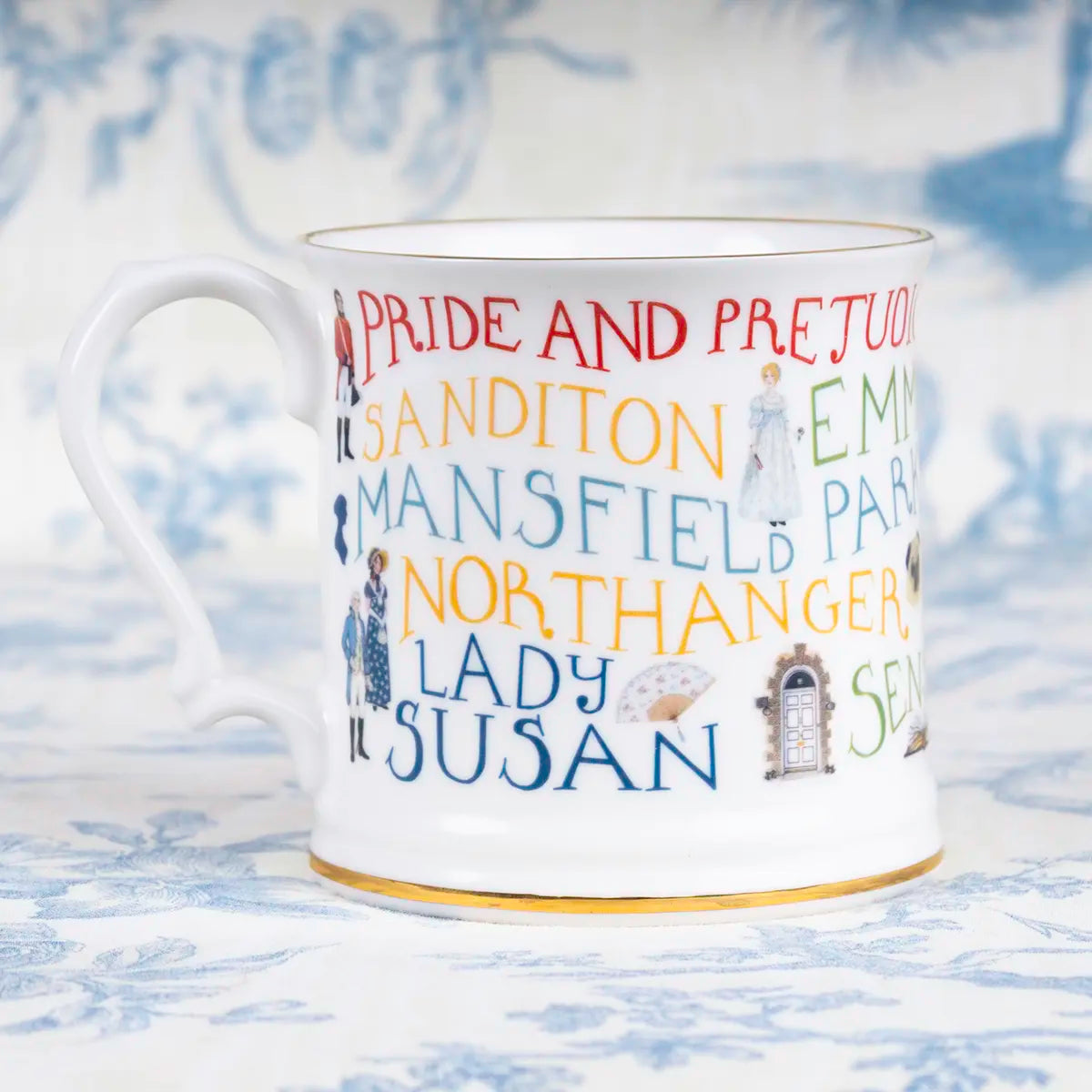a mug inscribed with the titles of Jane Austen's novels against a blue background