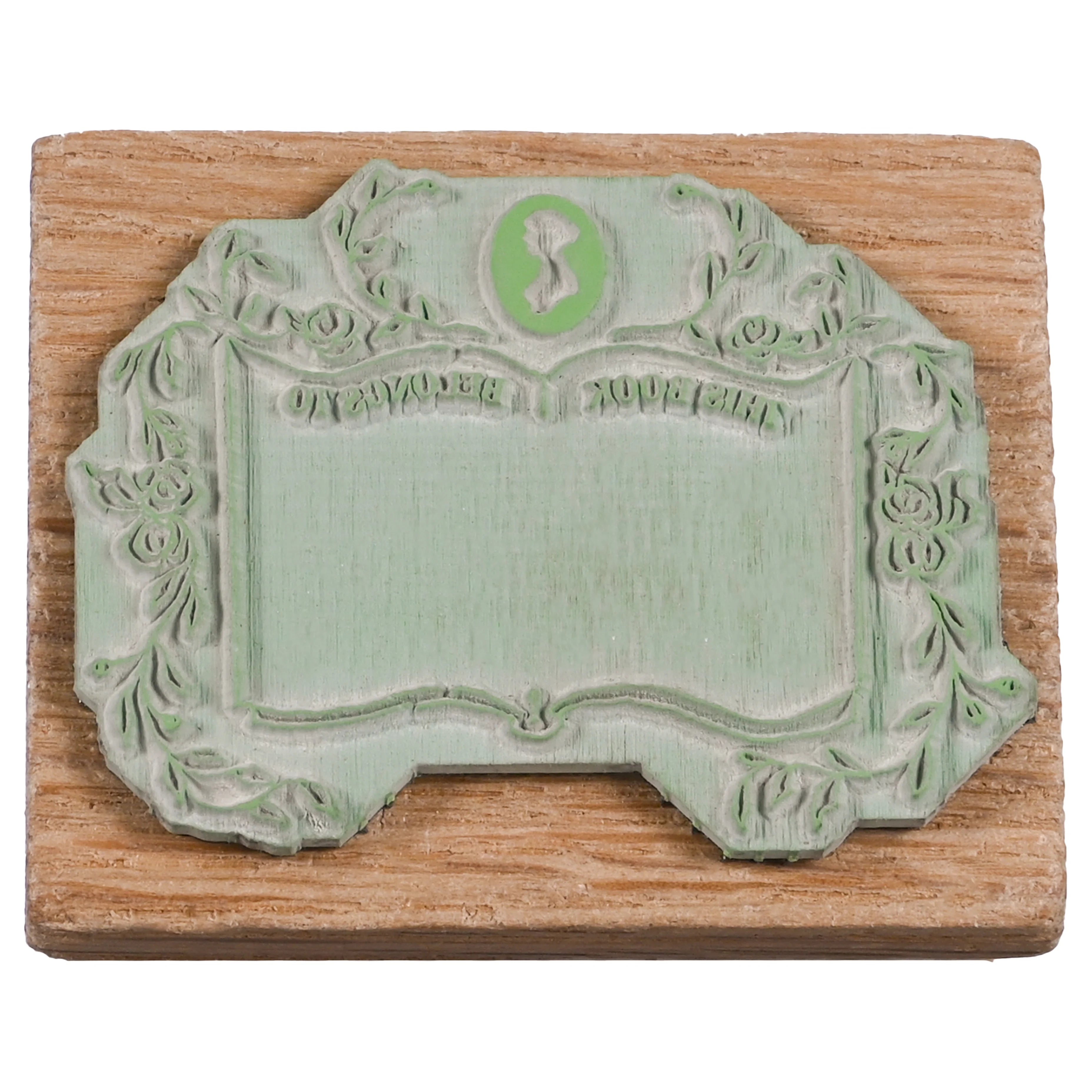 Wooden stamp with a Jane Austen logo, floral framing and backwards text  "This book belongs to"