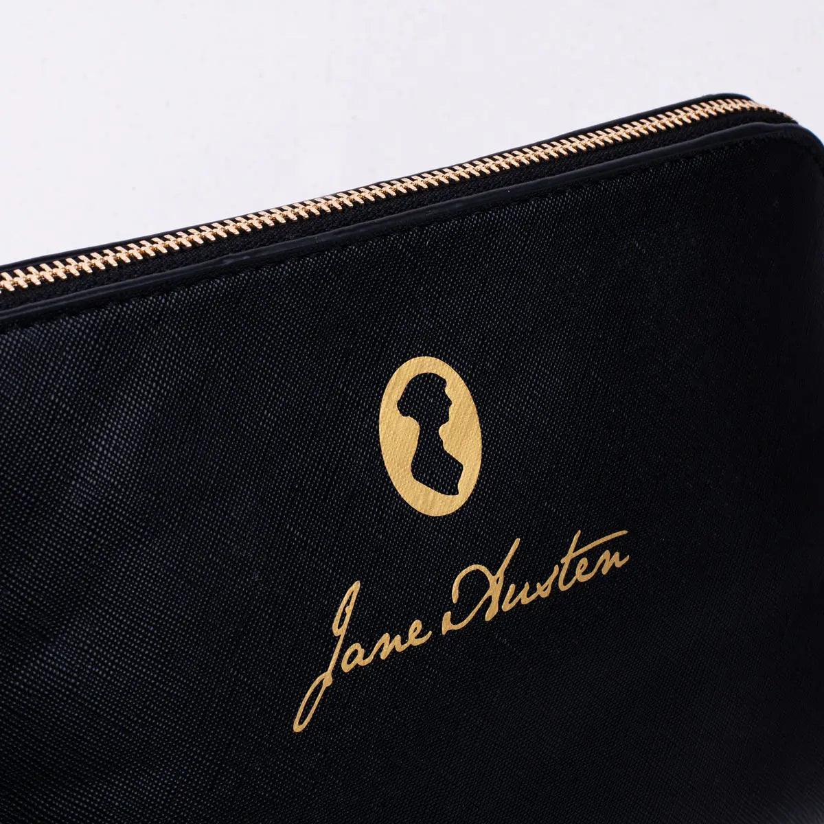 A faux leather cosmetics bag with Jane Austen's iconic signature and silhouette.&nbsp;