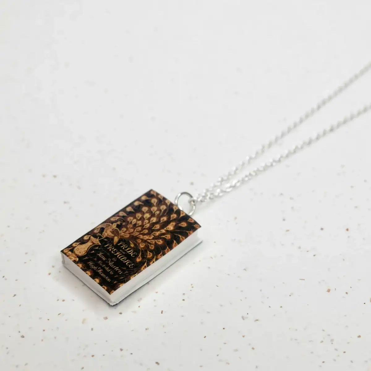 book page necklace on stone background