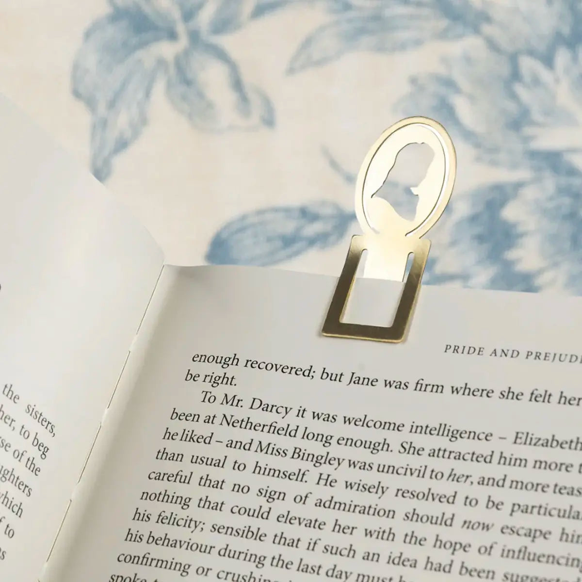 Brass pride and prejudice bookmark clipped into a copy of pride and prejudice
