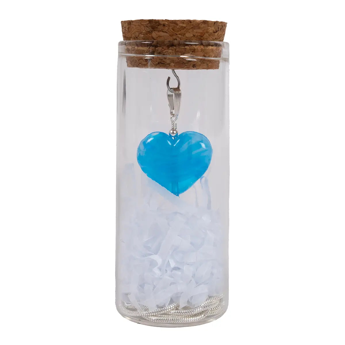blue glass heart pendant in a glass vial with cork, chain, and shredded tissue paper