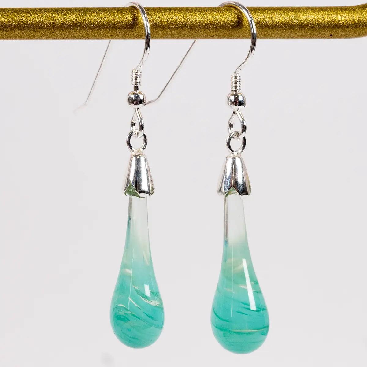 mint earrings against a white background