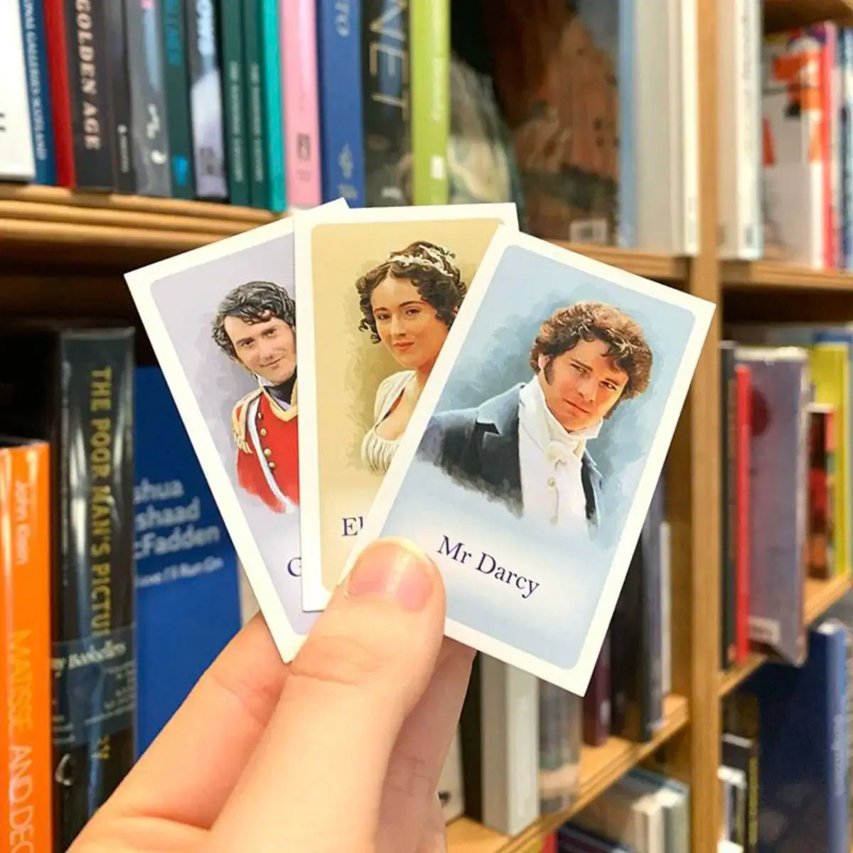 Jane Austen themed Guess Who cards in front of a bookshelf