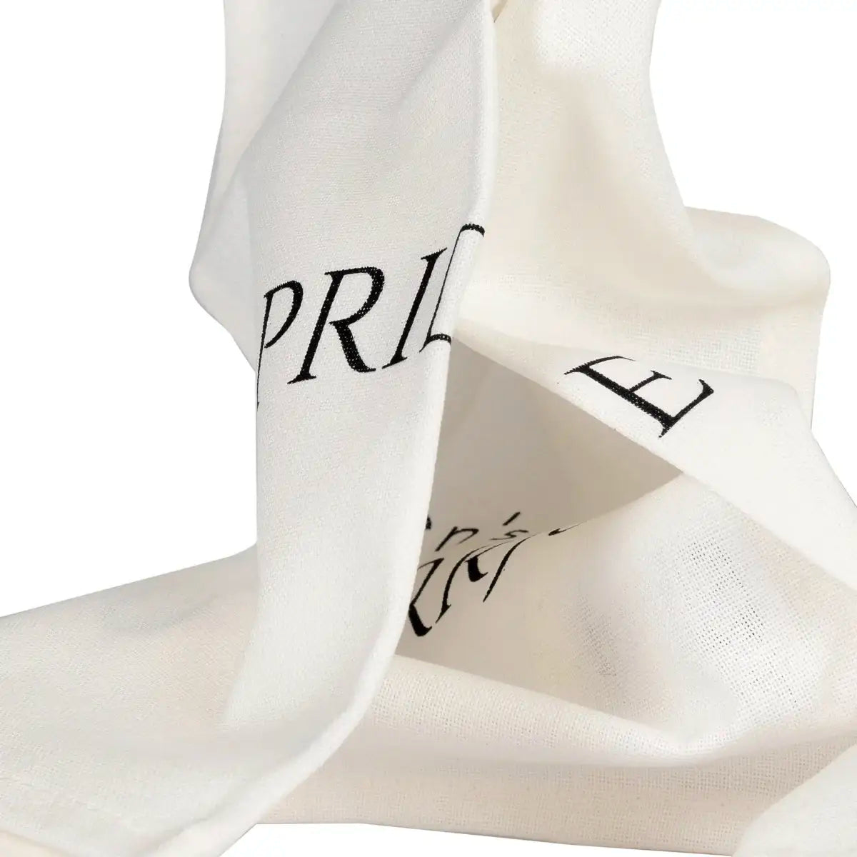 Folded white tea towel shows some of the letters of the words Pride and Puurjudice.