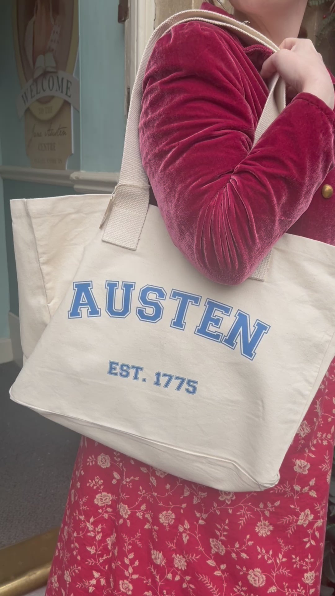 Varsity tote bag held by a Regency dressed woman on a windy day in Bath