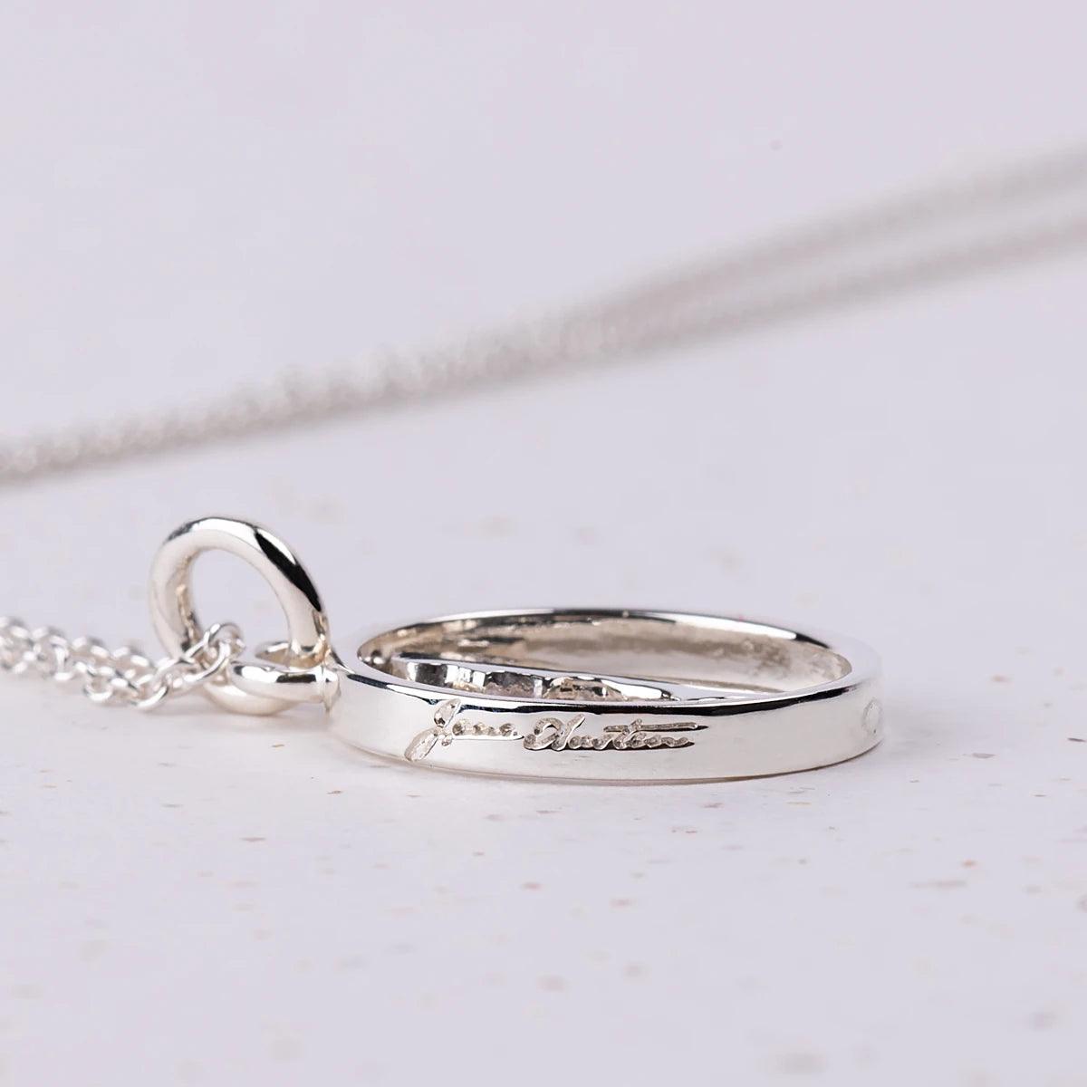 Close up of engraved jane Asuten text on Silver Spinner Necklace showing Jane Austen's Silhouette 