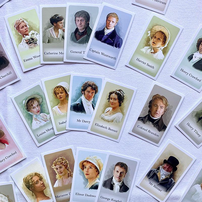 Mystery face cards laid out on the table displaying watercolour images of Elizabeth Bennet, Mr Darcy and other Jane Austen Characters