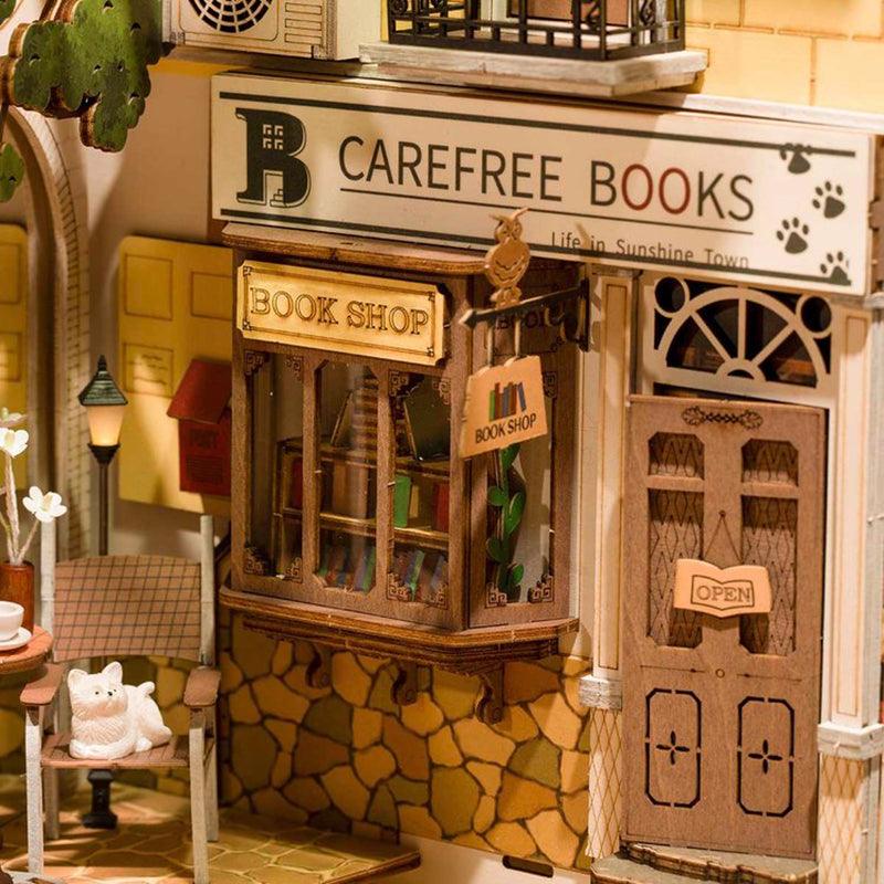 Here you can see the details of the book nook. It features a book shop with a decorated shop window. The shop appears to be made from brick and a smll sign hangs outside that reads "bookshop"