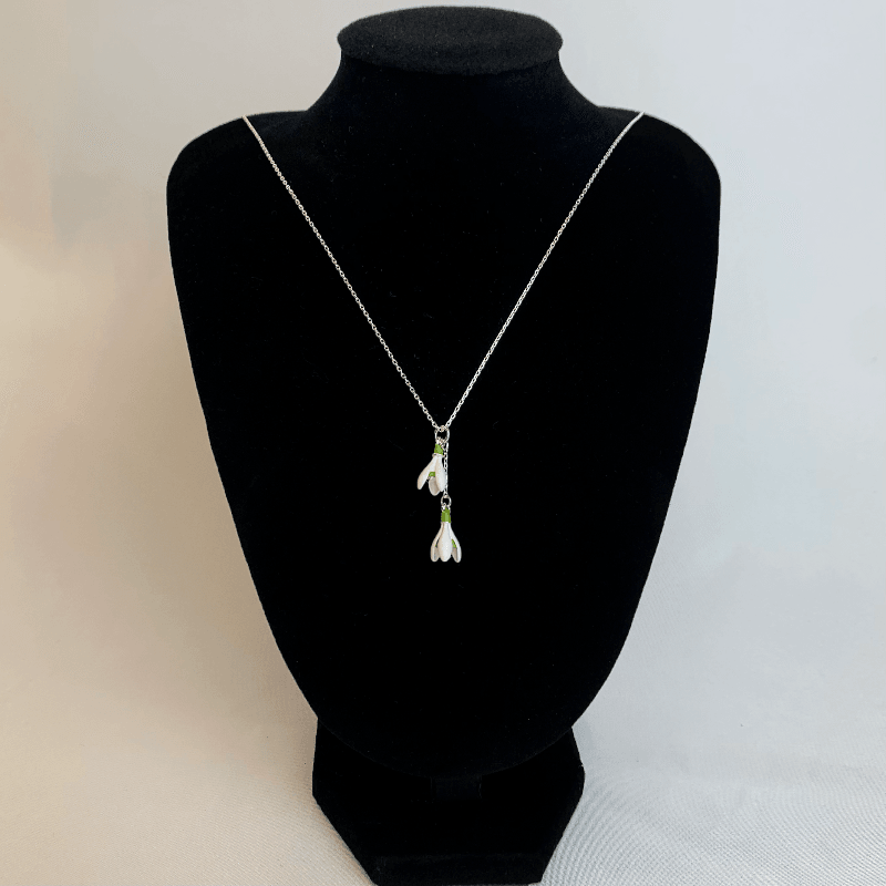 Here the snowdrop necklace is displayed hanging from a mannequin. Here you can see the pure white colour or the snowdrops and how they let the silver chain sparkle 